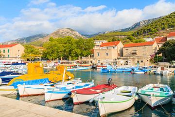 Fototapeta na wymiar Row of traditional fishing boats in Bol port, Brac island, Croatia