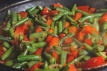 Dishes of green beans and red bell peppers top view