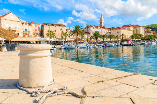 Pier in Supetar port with colorful houses and boats, Brac island, Croatia