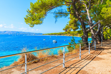 Obraz na płótnie Canvas View of beautiful sea coast from coastal walkway to Zlatni Rat at Bol on Brac island in summertime, Croatia