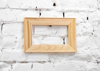 wooden frame on a white brick wall