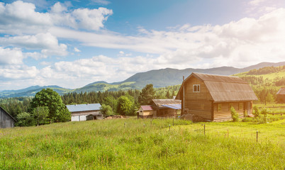 Fototapeta na wymiar Rural mountain Landscape with wooden houses in ukraininan Carpathian