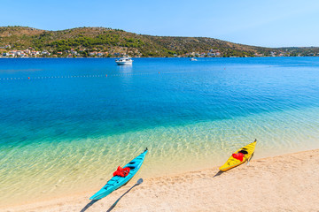 Two colorful kayaks on beach in Rogoznica town, Dalmatia, Croatia