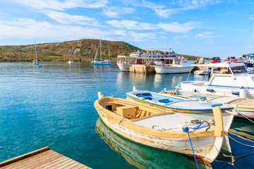 Fototapeta na wymiar Fishing boat mooring in small bay in Primosten town, Dalmatia, Croatia