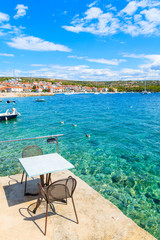Table of small coastal restaurant on pier in Primosten port, Dalmatia, Croatia