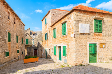 Street with typical stone houses in Postira old town, Brac island, Croatia