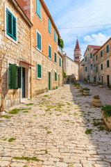 Naklejka premium Street with typical stone houses in Postira old town, Brac island, Croatia