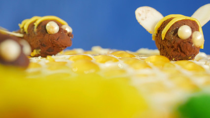 Beautiful honey cake decorated with bees of cream. Beautiful honey cake. Beautiful bee on the cake, closeup