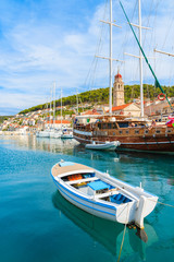 Obraz premium Fishing boat and wooden yacht in Pucisca port, Brac island, Croatia