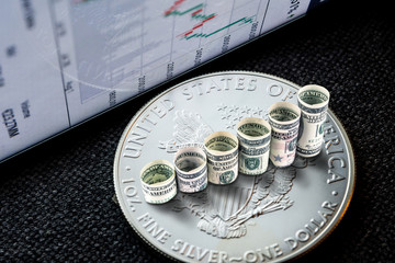 silver american eagle coin with dollars forming rising steps