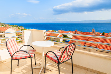 BOL TOWN, CROATIA - SEP 10, 2017: Two chairs with table on terrace of holiday apartment in Bol town, Brac island, Croatia. This island has famous port with beautiful old town.