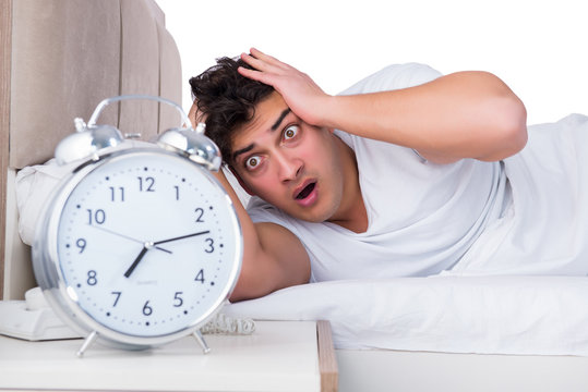 Man in bed suffering from insomnia