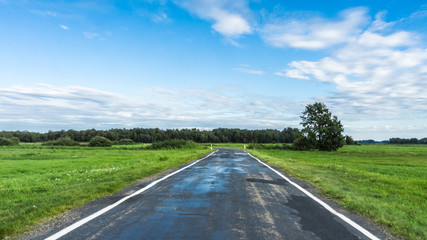 Road Amidst Field Against Sky