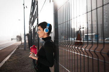 Woman listening to music while working out and jogging outdoor