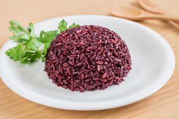 Black rice cooked on white plate