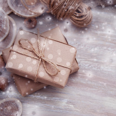Christmas brown gift boxes with snowflakes on rustic background