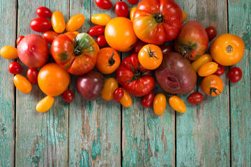 Fototapeta na wymiar Colorful tomatoes, red , yellow, orange , green,black tomatoes. autumn background. vintage wooden background
