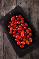 Colorful tomatoes, red cherry tomatoes , autumn background. vintage wooden background