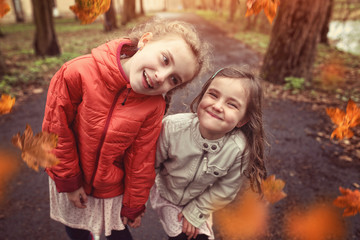 Naklejka premium Friendship of two young girls in autumn day