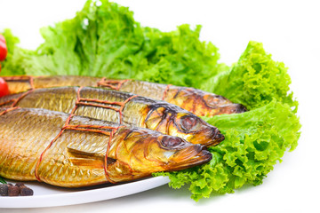 Smoked fish on plate close up