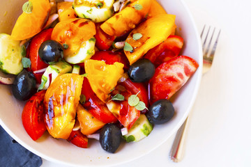 Healthy vegetables salad with tomatoes, cucumbers ,onion and olives