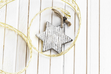 Wooden star Christmas decoration with ribbon on white background