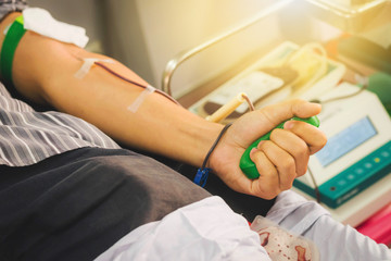 Blood donor at a donation with a bouncy ball in hand.