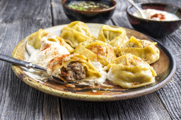 Traditional Turkish manti with joghurt and vinegar as close-up on a plate