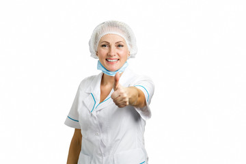 Female doctor showing thumb up. Portrait of positive smiling female surgeon showing sign ok raising thumb up on white background.