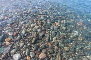 pebbles on the seabed transparent water