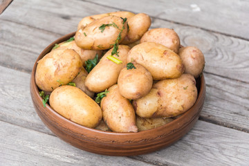 Delicious hot baked potatoes in rustic plate