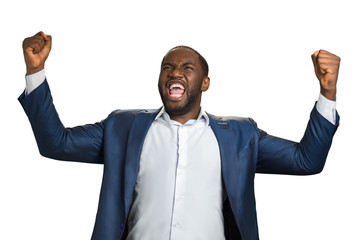 Handsome businessman emotionally shouting yes. Cheerful successful businessman with fists raised,...