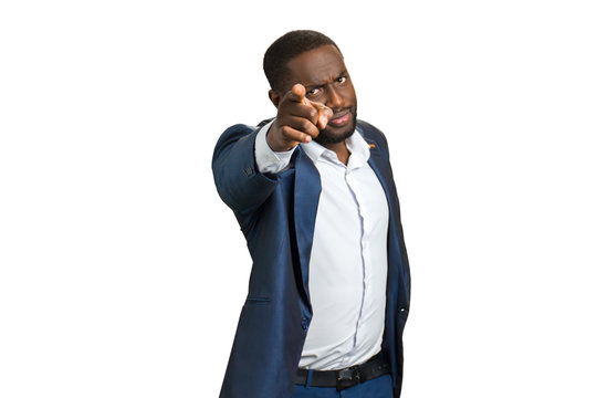 Confident buainessman pointing at camera. Handsome black man pointing on white background.