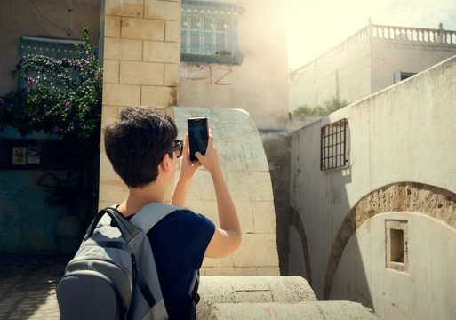 Girl photographing the phone of the old city of Medina. Journey. Tunisia.