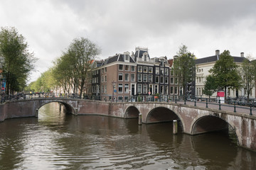 View of Keizersgracht and famous touristic place in Amsterdam canals with bridge, Netherlands