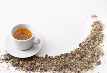 Herbal tea from medicinal  herbs in a cup on white