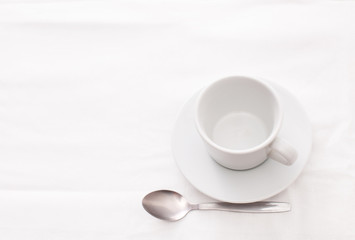 Empty white Cup of tea with spoon on white