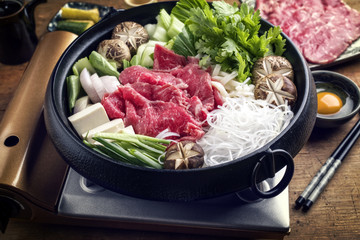 Traditional Japanese sukiyaki with kobe beef as close-up in a pot