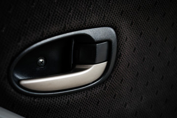 Door handle in car (vehicle) is button close (lock) before driving - safety, secure and protect anti-theft protection concept.
