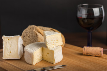 variety of french cheese with a glass of wine