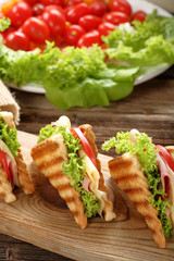 Fresh sandwiches on wooden background