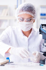 Female scientist researcher conducting an experiment in a labora