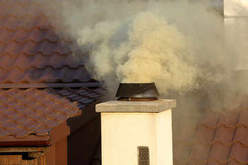 Smoke coming out of the old chimney house