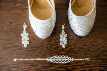 Beautiful set of wedding accessories, white shoes, pearl and earrings
