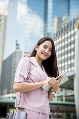 Fototapeta premium Young asian business lady working outdoors