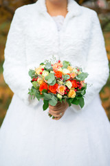 colourful wedding bouquet in bride's hands white background