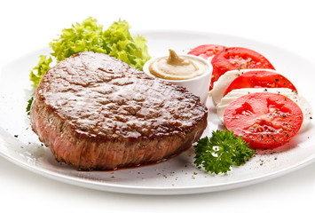 Grilled beef steak with mozzarella and vegetables on white background 