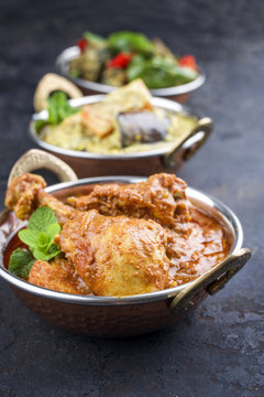 Traditional Indian curries with chicken and vegetable as close-up in korai