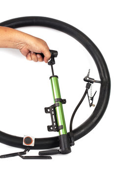 hand pumping air into bike tire