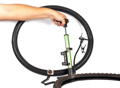 hand pumping air into bike tire
